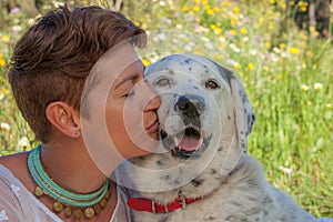 Woman kissing pet rescue dog photo