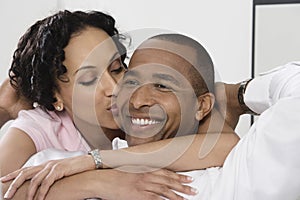 Woman Kissing Smiling Man