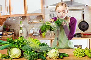 Woman in kitchen having vegetables holding shopping basket