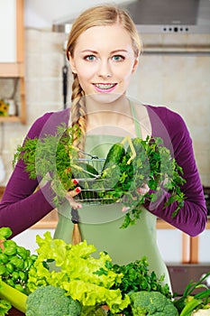 Woman in kitchen having vegetables holding shopping basket