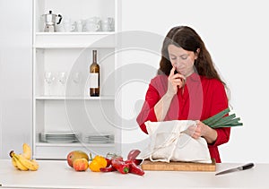 Woman in the kitchen with her food shopping