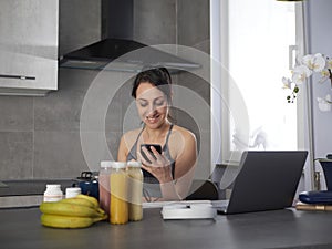 woman in the kitchen at home is preparing fruit or a healthy smoothie and having fun