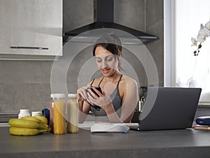 woman in the kitchen at home is preparing fruit or a healthy smoothie and having fun