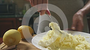 A woman in the kitchen makes a cake. Preparation of cream. 4k, slow-motion shooting. bodily shot