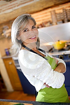 Woman in kitchen ready to cook