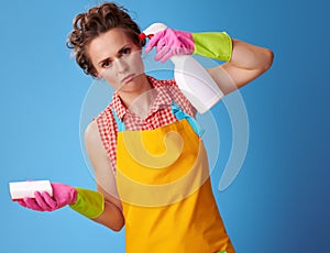 Woman with kitchen sponge wanting to shoot herself from bottle