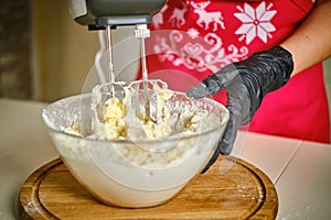 Woman in the kitchen using a cream cake mixer. Vercion 2