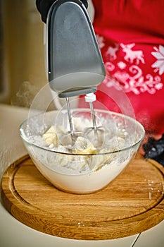 Woman in the kitchen using a cream cake mixer. Vercion 3