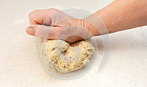 Woman kneading bread dough by hand