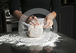 Woman Kneading Dough photo