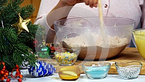 Woman is kneading dough for Christmas cookies