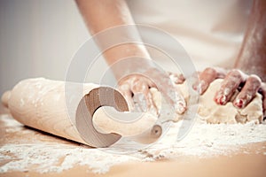 Woman kneading dough photo