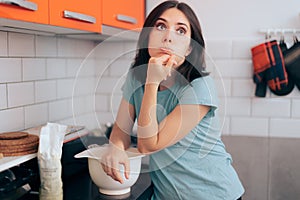 Woman Kneading Dough in the Kitchen