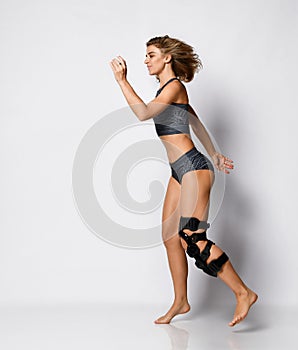 Woman with knee brace. Isolated.