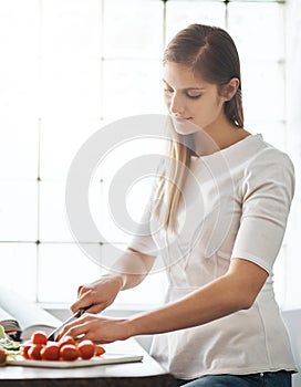 Woman, knife and vegetables with food in kitchen for lunch, vegan meal and healthy diet with nutrition. Female person