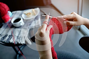Woman knits woolen circle scarf, Knitting needles