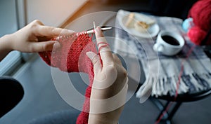 Woman knits woolen circle scarf, Knitting needles