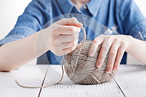 The woman knits woolen clothes. Knitting needles. Close-up. natural wool