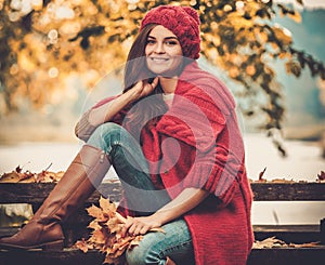 Woman in knitted coat in autumn park