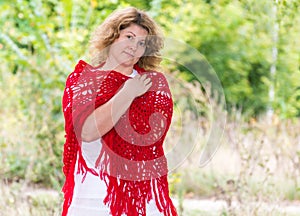 Woman in knitted shawl in nature