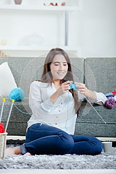 Woman knitting in living room photo