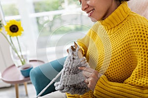 Woman knitting s scarf