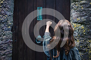 Woman knocking on door photo