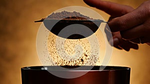 Woman knocking strainer with cocoa to sprinkle in bowl