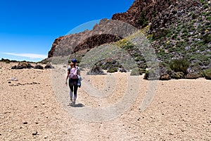 Woman on La Canada de los Guancheros dry desert plain with view on volcano Pico del Teide, Mount El Teide National Park, Tenerife photo