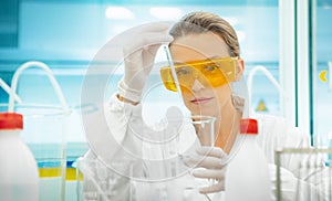Woman in lab with equipments, pipettes