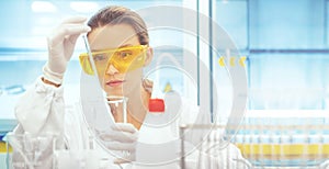 Woman in lab with equipments, pipettes photo