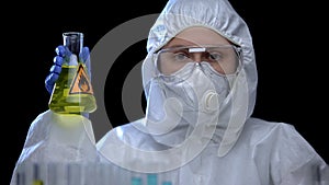 Woman laboratory assistant holding flask with flammable liquid, toxic igniter