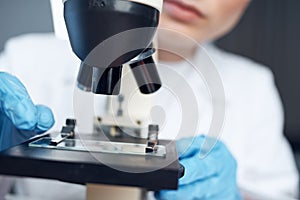 woman laboratory assistant microscope setting research microbiology