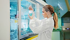 Woman in laboratory with pipettes, researcher