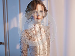 Woman in lace dress at the window