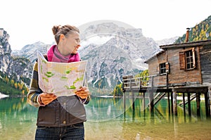 Woman at Lake Bries holding an open map and smiling