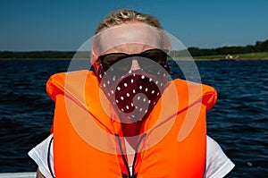 Woman in the lake with life jackets and face mask, Covid-19, coronavirus