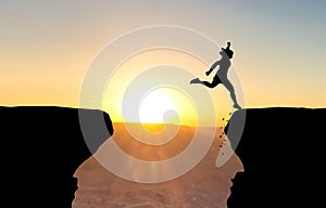 Woman landing after jump over abyss. photo