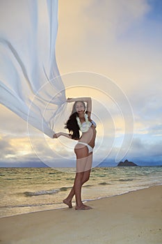 Woman on lanikai beach at sunrise