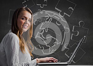 Woman at laptop against grey wall with white jigsaw doodle