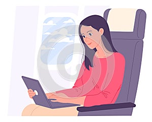 Woman with laptop in airplane works during flight