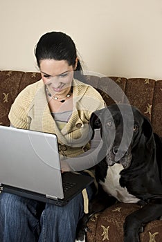 Woman with laptop and a big dog