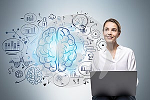 Woman with laptop and brain sketch