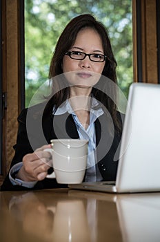 Woman with laptop and coffee