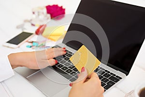 Woman with laptop computer and credit card