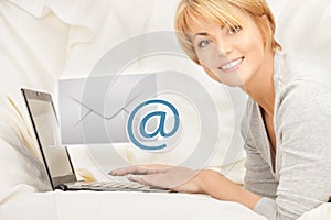 Woman with laptop computer sending e-mail