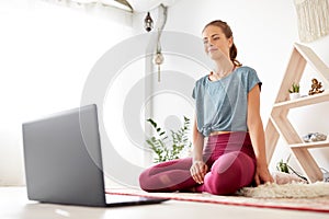 Woman with laptop computer at yoga studio