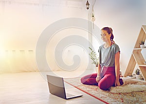 Woman with laptop computer at yoga studio