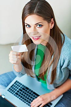 Woman, laptop. credit card. Shpping on couch. photo