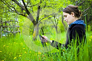 Woman with laptop in field